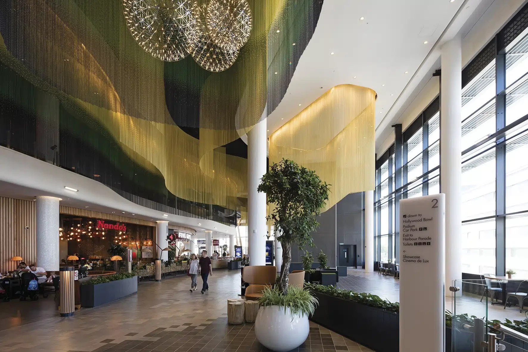 Fluted glass and custom metal screen dividers for hotel and apartment interiors.