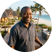 Robert Mwangi, hotel investor standing in front of his beach resort in Kenya. He successfully utilized George Group's complete turnkey building material solution and hassle-free DDP shipping service.