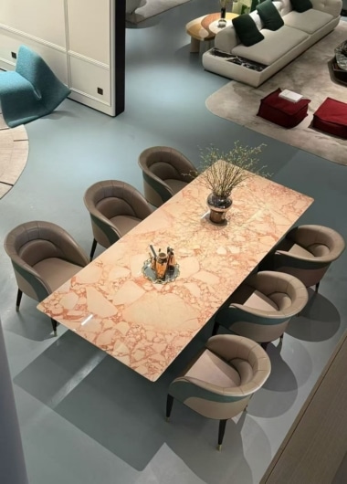 Contemporary dining room furniture with marble tables and leather chairs.